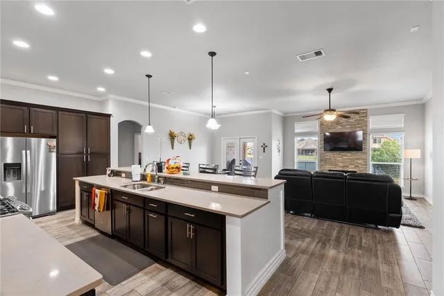 a kitchen with stainless steel appliances granite countertop a sink stove and refrigerator