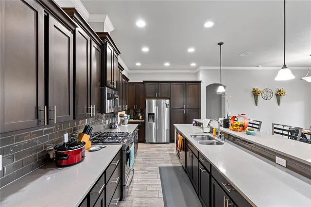 a kitchen with lots of counter space and stainless steel appliances