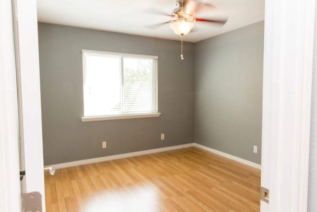 4209 Burnet Road, Unit 206 Austin, TX 78756 - Photo 13 of 20 Hardwood flooring extends throughout this naturally illuminated room, complete with a ceiling fan for optimal airflow.