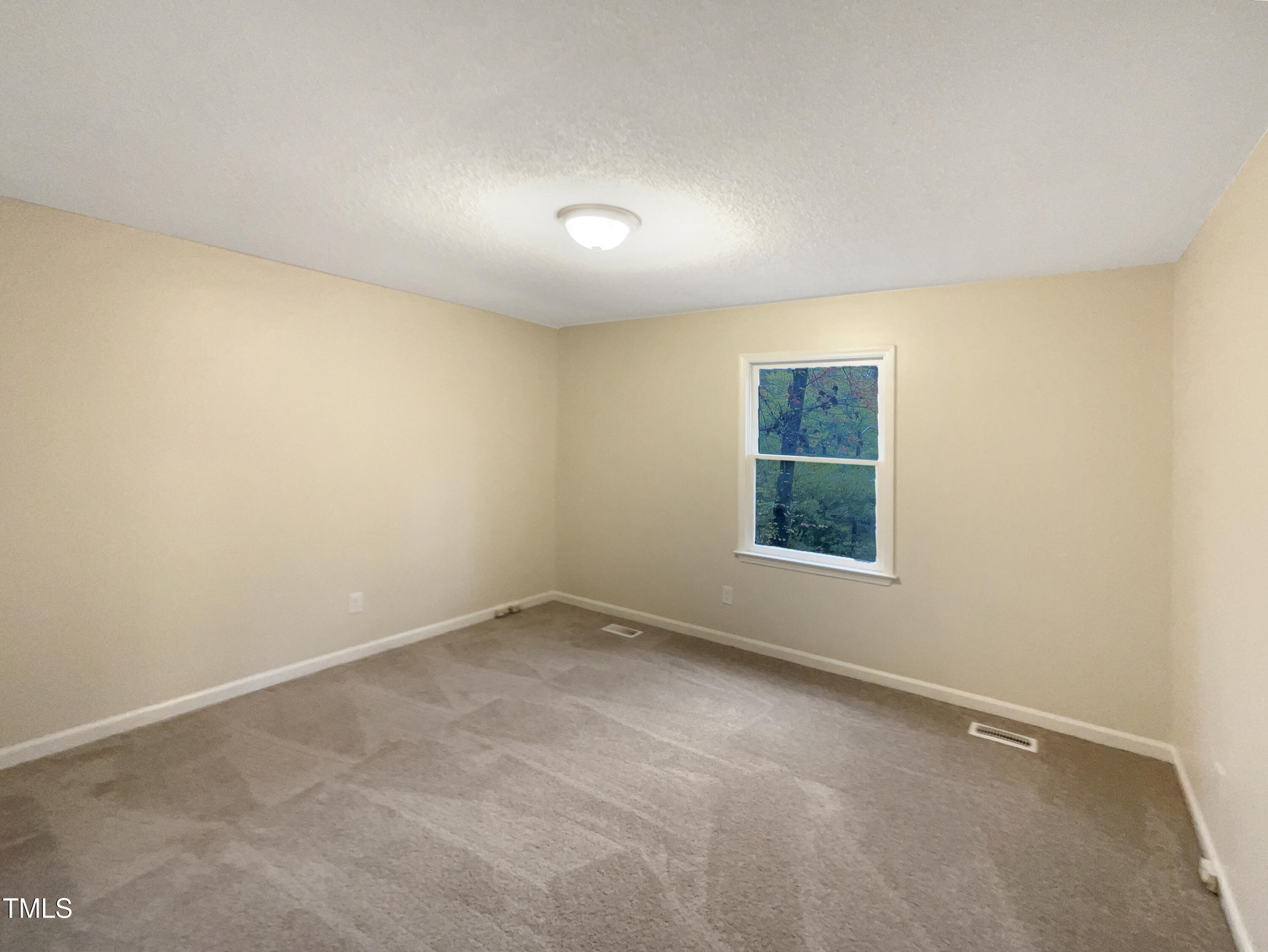 6605 Glendower Road Raleigh, NC 27613 - Photo 5 of 23 an empty room with a window