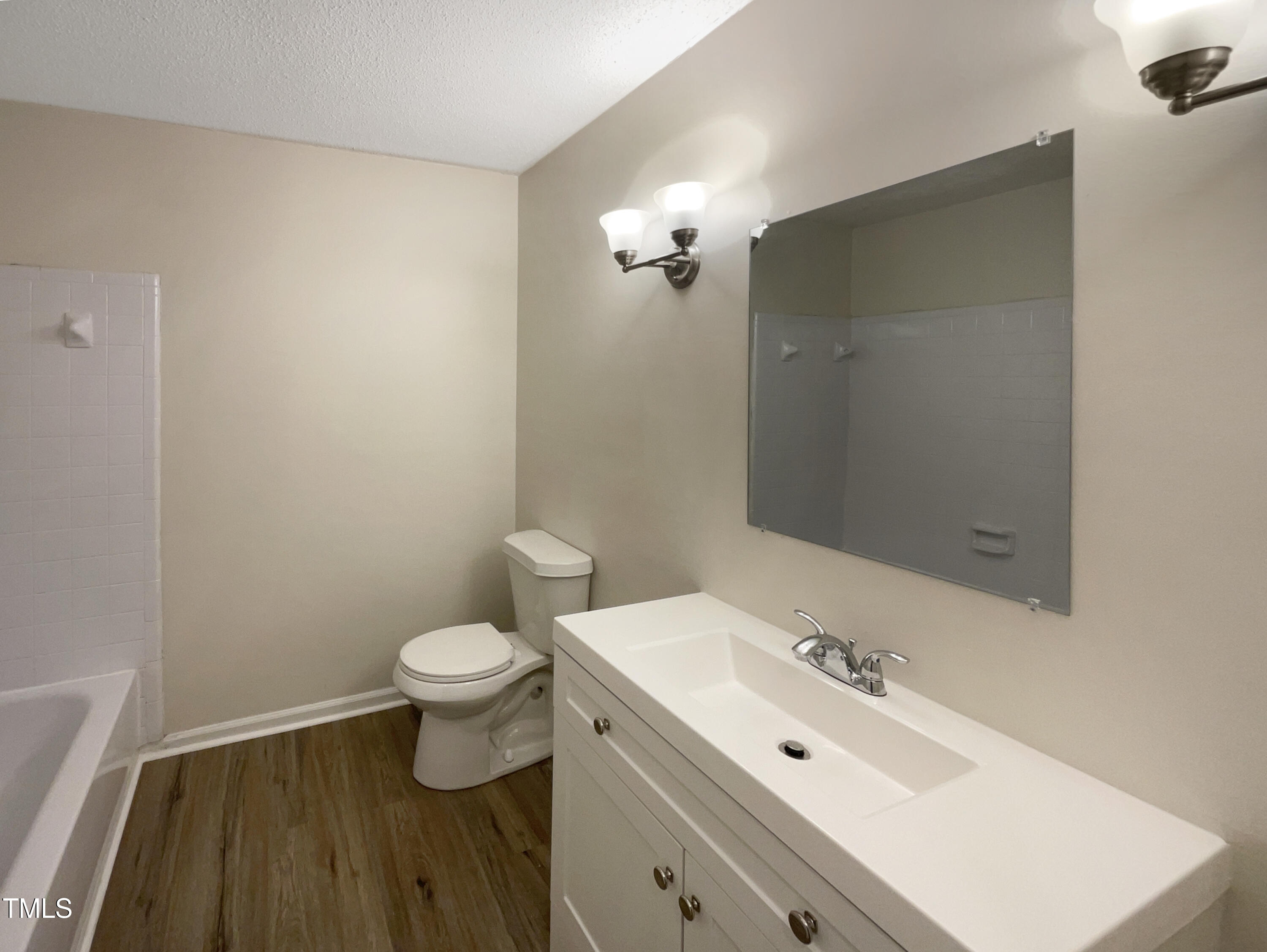 6605 Glendower Road Raleigh, NC 27613 - Photo 7 of 23 a bathroom with a toilet sink and a mirror