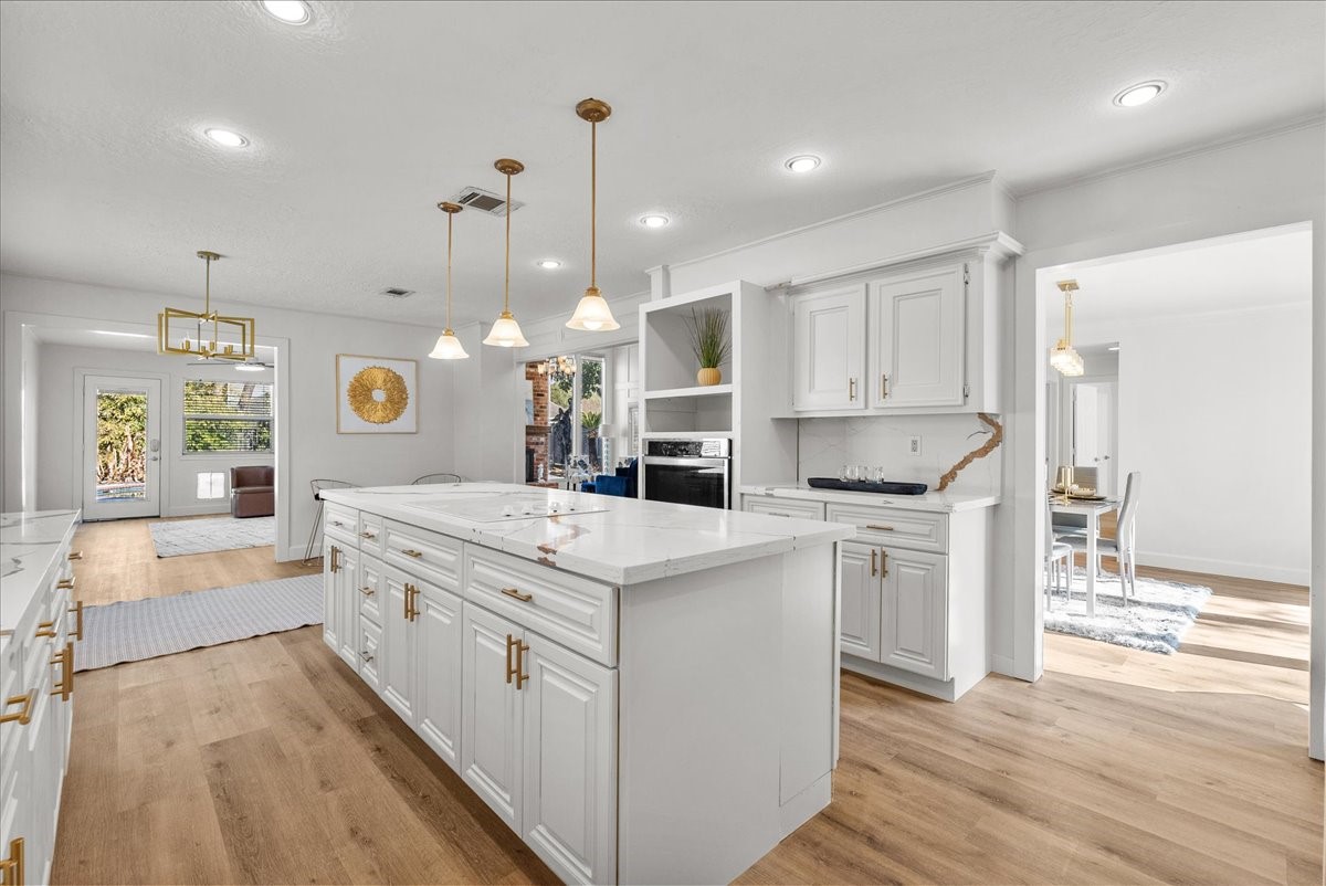 6702 Robinwick Court Spring, TX 77379 - Photo 13 of 41 a large white kitchen with lots of counter space a sink appliances and cabinets