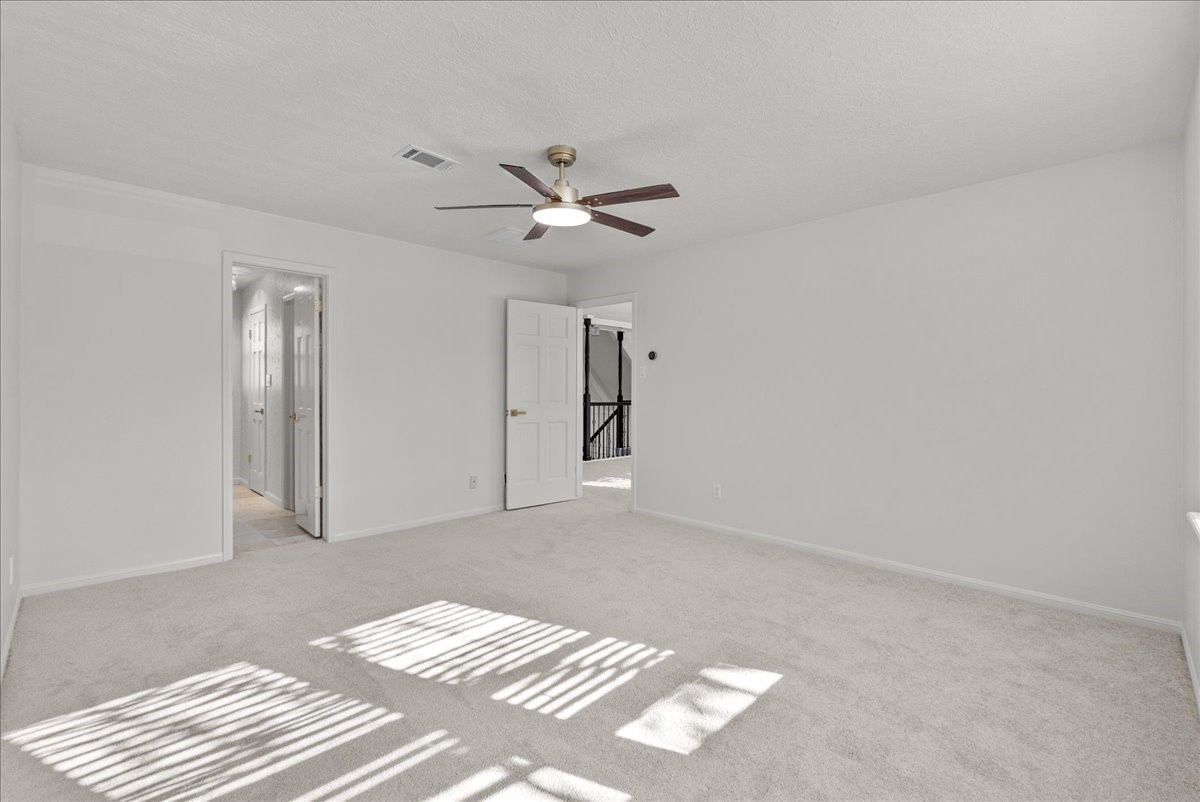 6702 Robinwick Court Spring, TX 77379 - Photo 27 of 41 a view of a bedroom with a ceiling fan and a chandelier fan