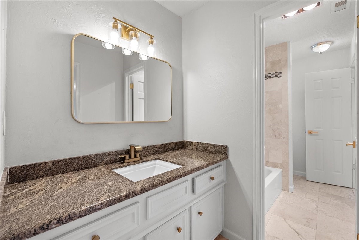 6702 Robinwick Court Spring, TX 77379 - Photo 30 of 41 a bathroom with a granite countertop double vanity sink and mirror