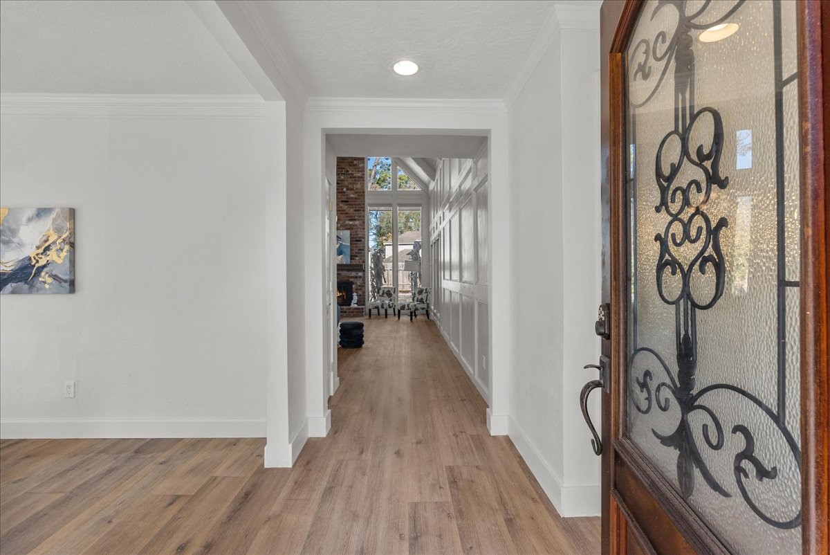 6702 Robinwick Court Spring, TX 77379 - Photo 3 of 41 a view of a hallway with wooden floor and a sink