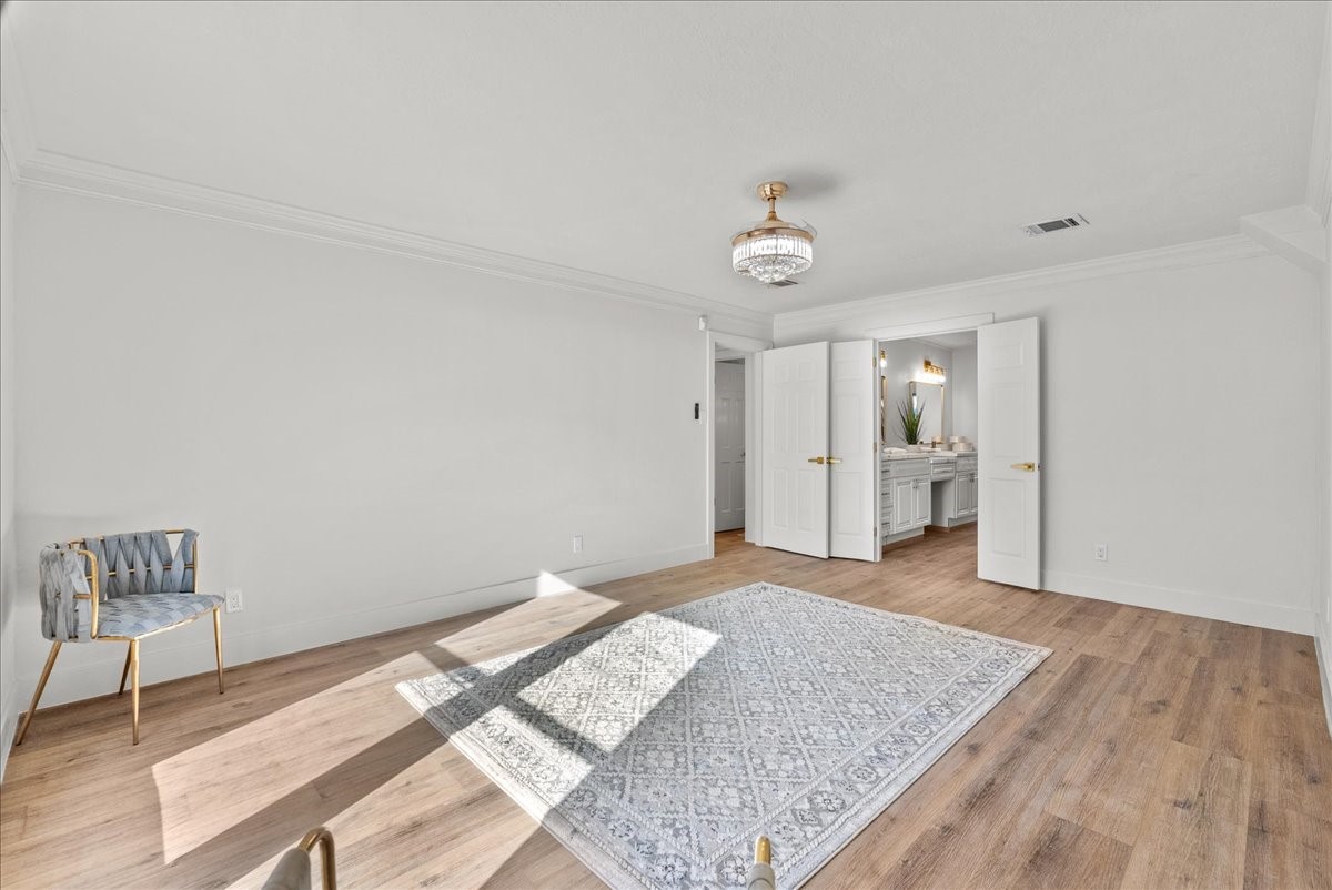 6702 Robinwick Court Spring, TX 77379 - Photo 9 of 41 a bedroom with a bed and a chandelier