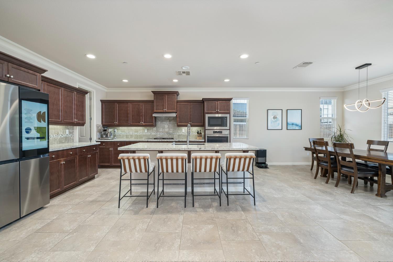 3573 Hermosa Avenue Clovis, CA 93619 - Photo 11 of 42 a kitchen with kitchen island granite countertop lots of counter top space and furniture