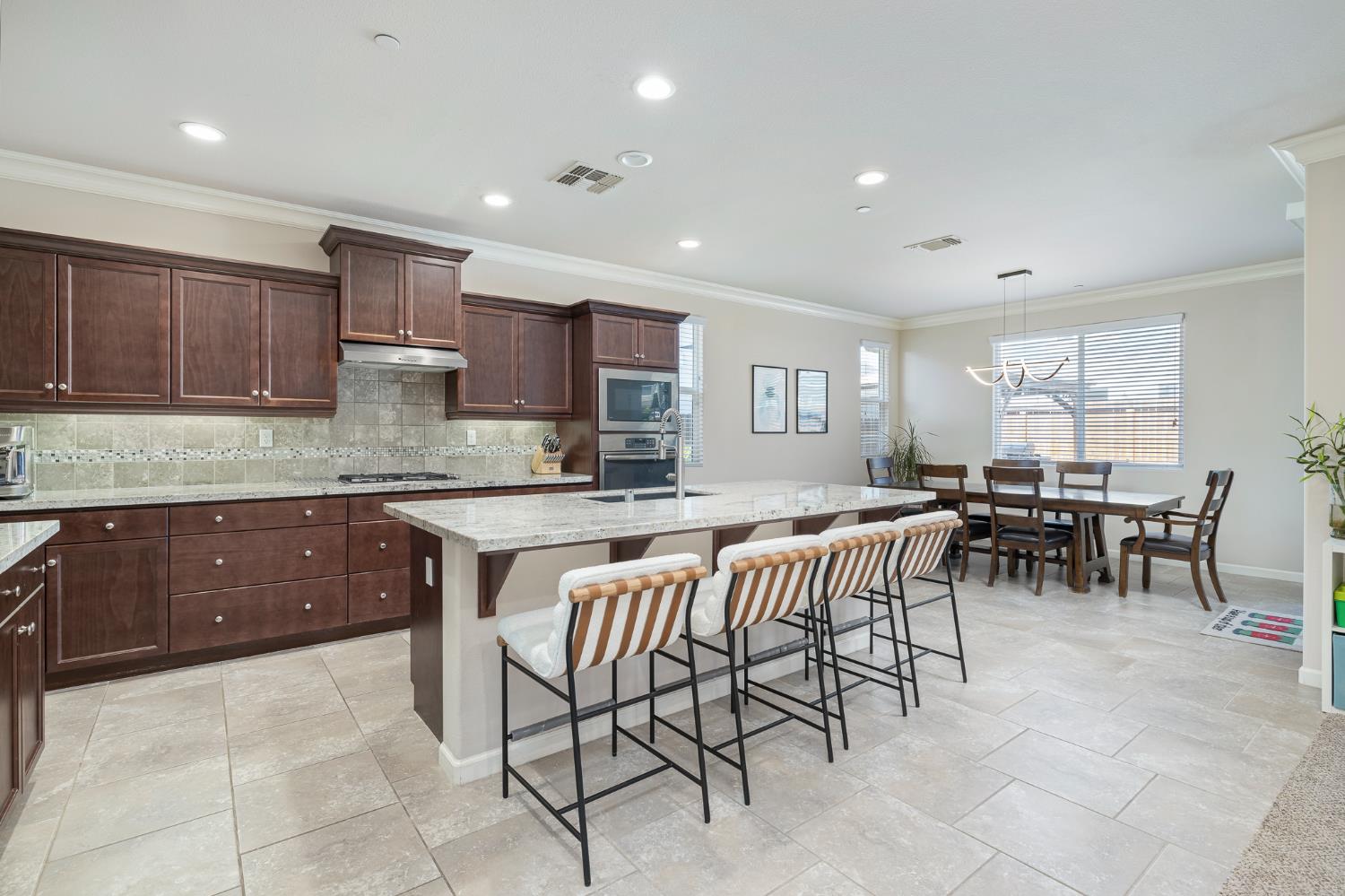 3573 Hermosa Avenue Clovis, CA 93619 - Photo 12 of 42 a kitchen with a dining table chairs and view kitchen