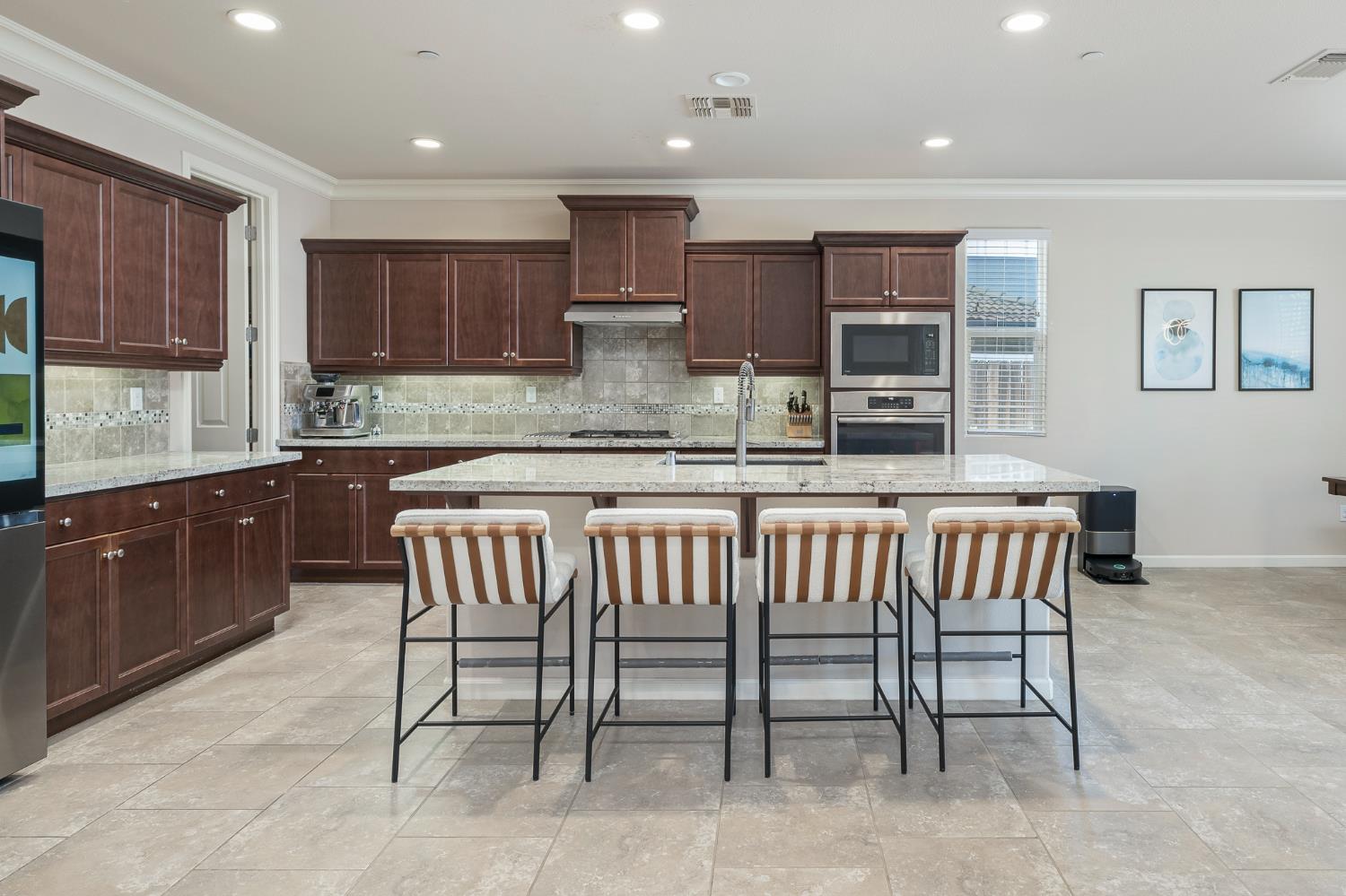 3573 Hermosa Avenue Clovis, CA 93619 - Photo 13 of 42 a kitchen with a table chairs sink microwave and cabinets