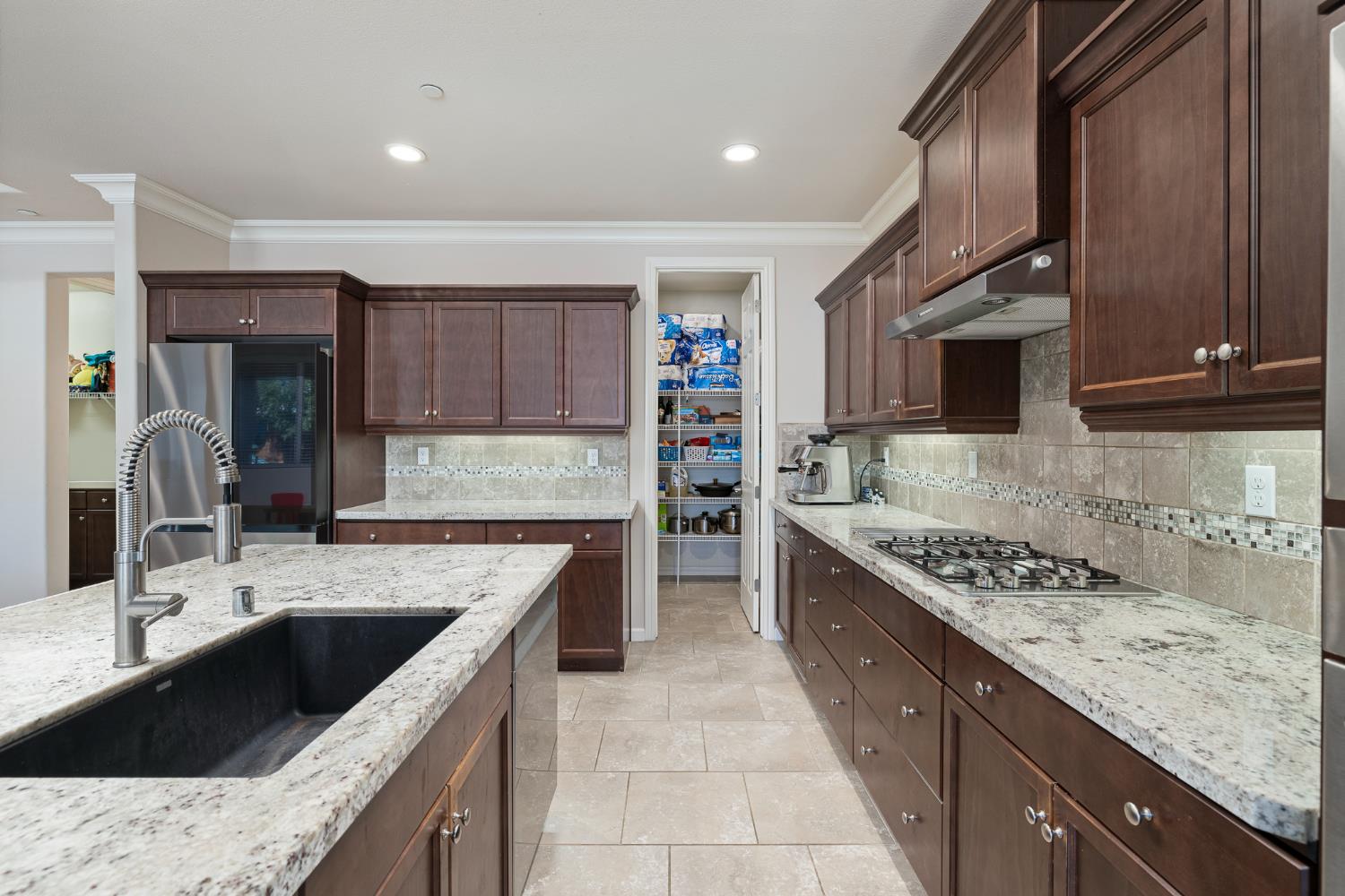 3573 Hermosa Avenue Clovis, CA 93619 - Photo 17 of 42 a kitchen with stainless steel appliances granite countertop a sink stove and cabinets