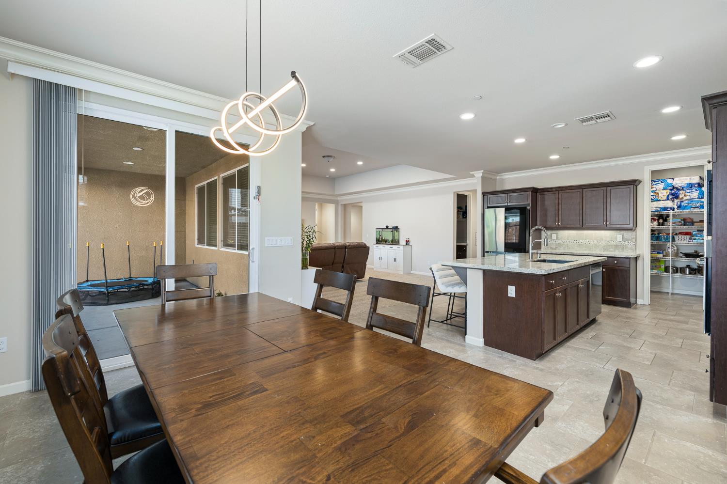 3573 Hermosa Avenue Clovis, CA 93619 - Photo 19 of 42 a large kitchen with a table and chairs in it