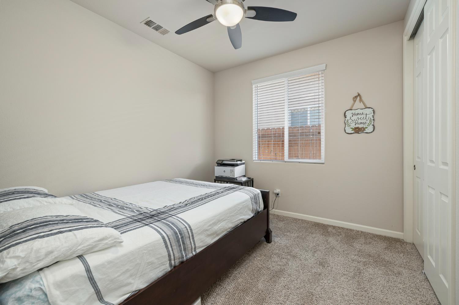 3573 Hermosa Avenue Clovis, CA 93619 - Photo 24 of 42 a bedroom with a bed and a window