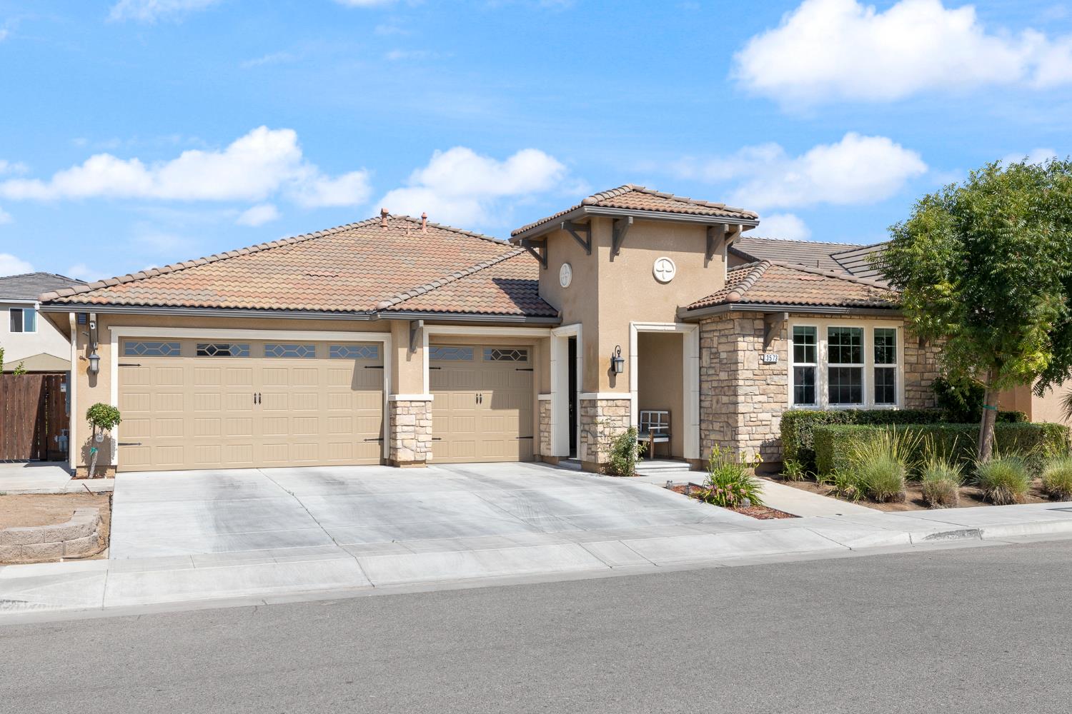 3573 Hermosa Avenue Clovis, CA 93619 - Photo 3 of 42 a front view of a house with a garden and pathway