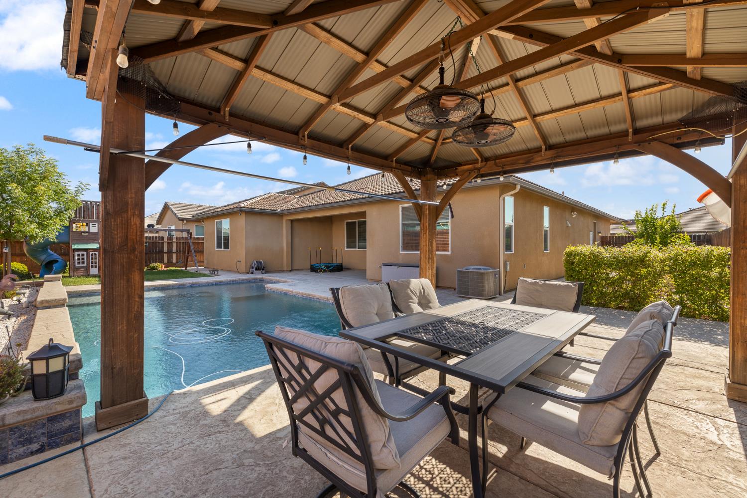 3573 Hermosa Avenue Clovis, CA 93619 - Photo 40 of 42 a view of a patio with table and chairs and potted plants