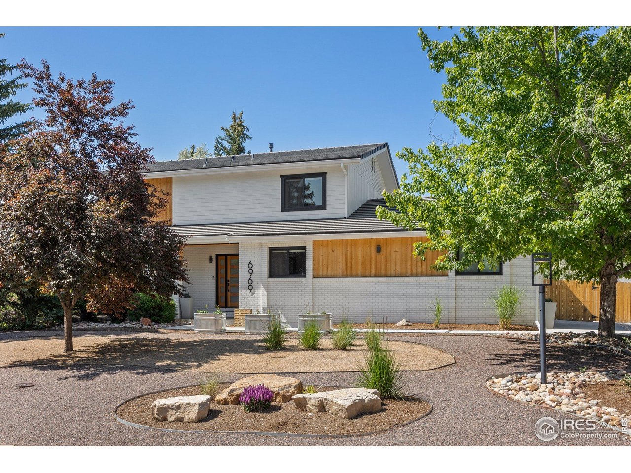 6969 Harvest Road Boulder, CO 80301 - Photo 1 of 39 a front view of a house with a yard