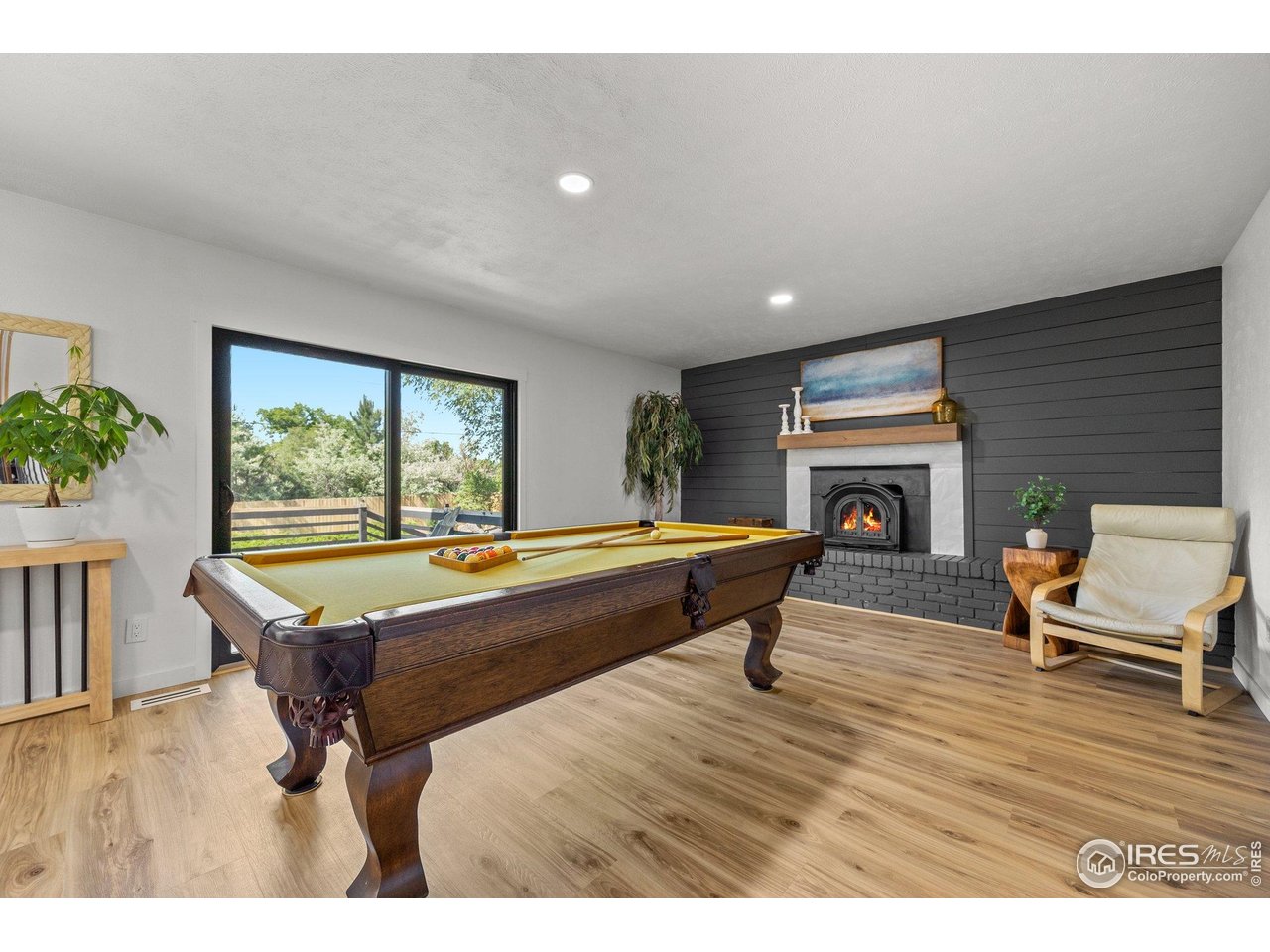 6969 Harvest Road Boulder, CO 80301 - Photo 11 of 39 a living room with a pool table and a fireplace