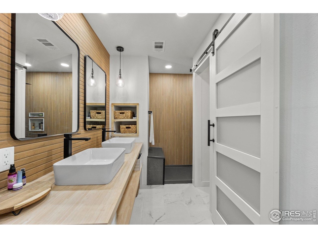 6969 Harvest Road Boulder, CO 80301 - Photo 17 of 39 a bathroom with a double vanity sink a mirror and a shower