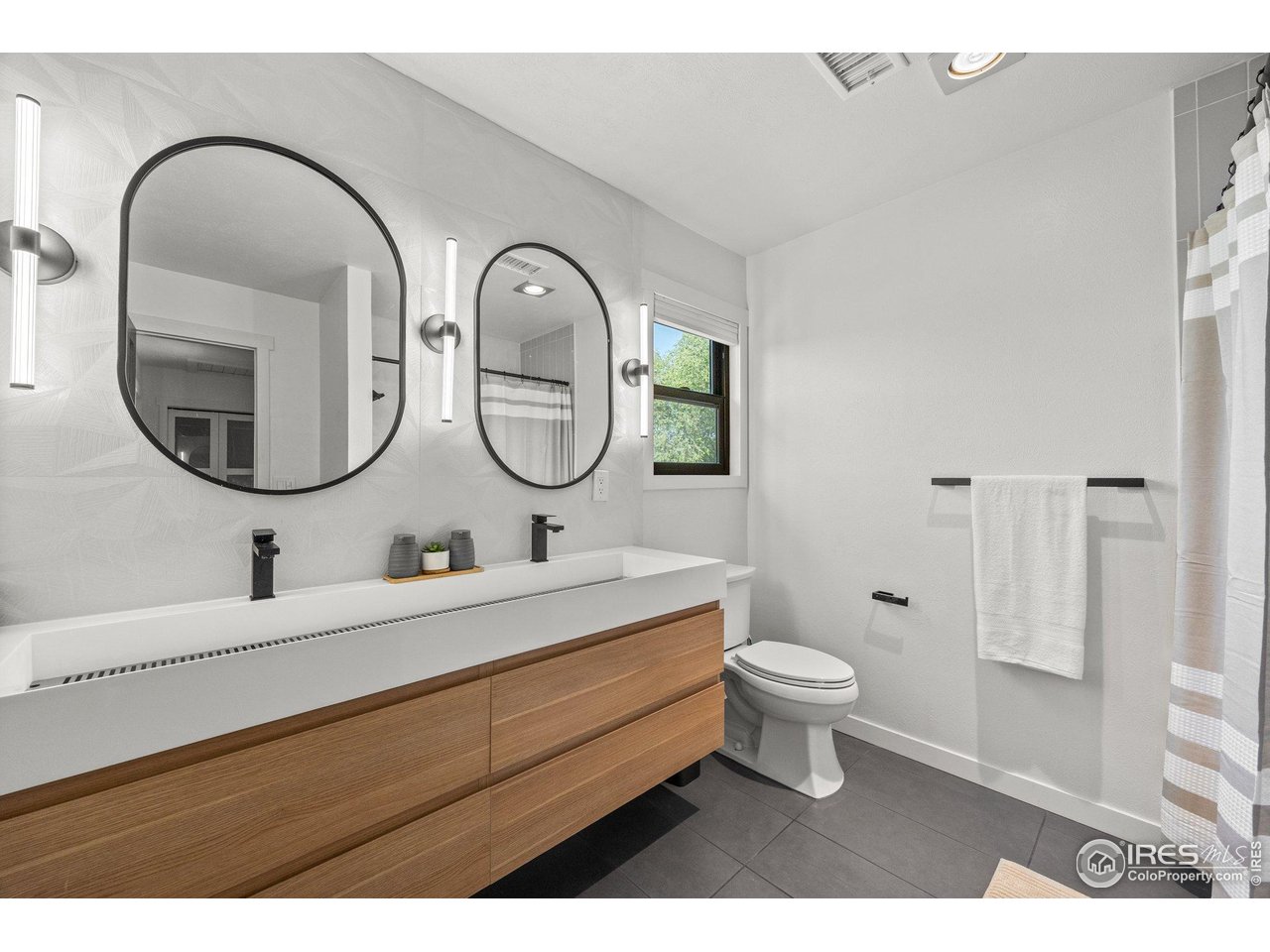 6969 Harvest Road Boulder, CO 80301 - Photo 19 of 39 a bathroom with a toilet a sink and a mirror