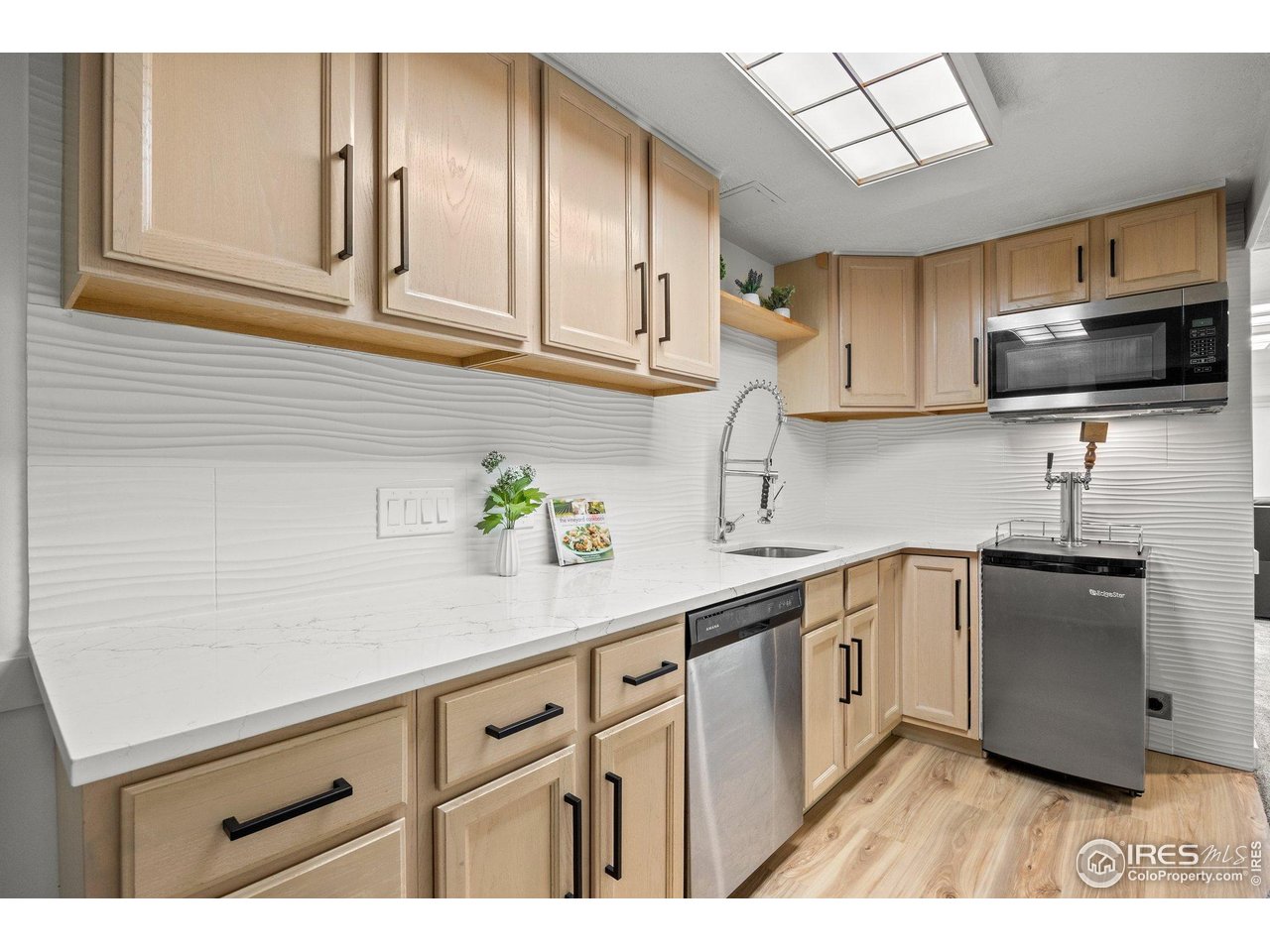 6969 Harvest Road Boulder, CO 80301 - Photo 21 of 39 a kitchen with stainless steel appliances granite countertop a sink dishwasher stove and microwave with wooden cabinets