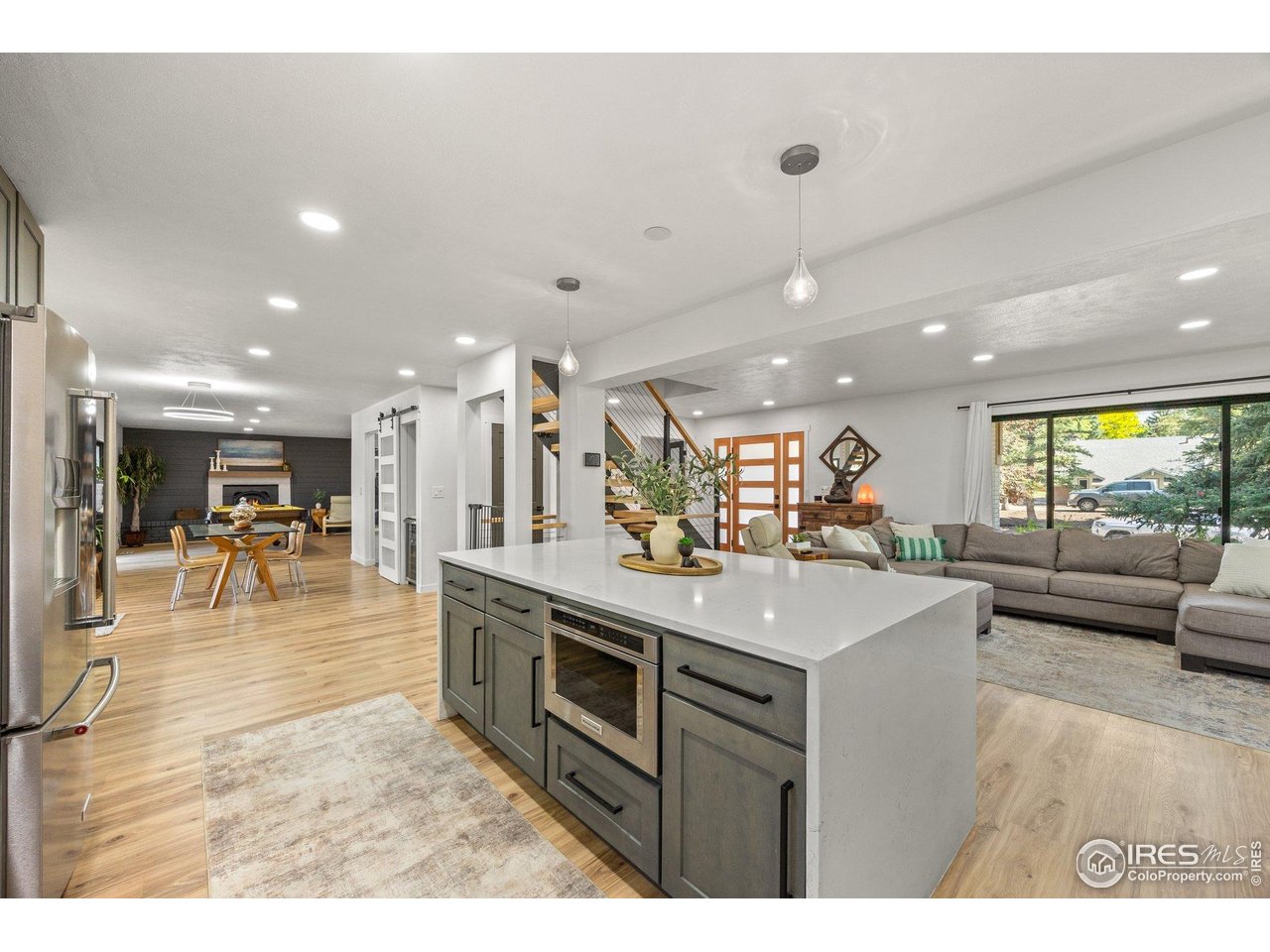 6969 Harvest Road Boulder, CO 80301 - Photo 8 of 39 a kitchen with stainless steel appliances granite countertop a stove a sink a refrigerator and a dining table with wooden floor