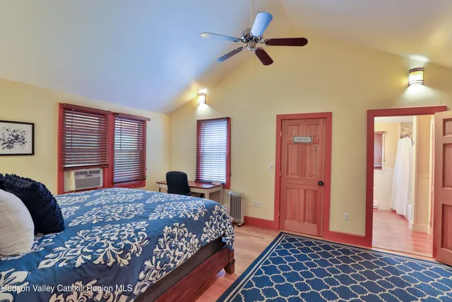 a bedroom with a large bed and a chandelier