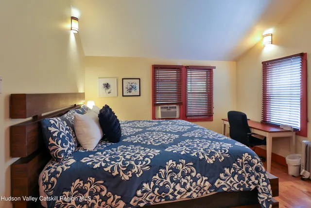 a bedroom with a large bed and a window