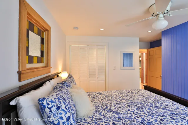 a bedroom with a bed dresser and a window