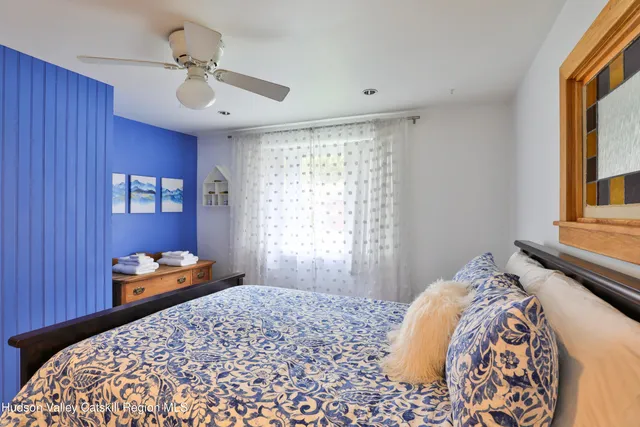 a bedroom with a bed and window