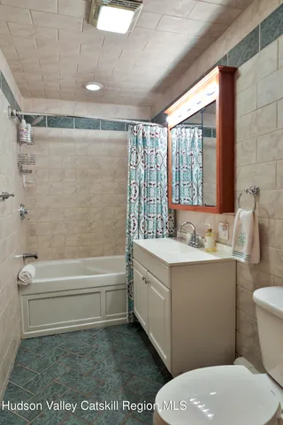 a bathroom with a sink a toilet and bathtub