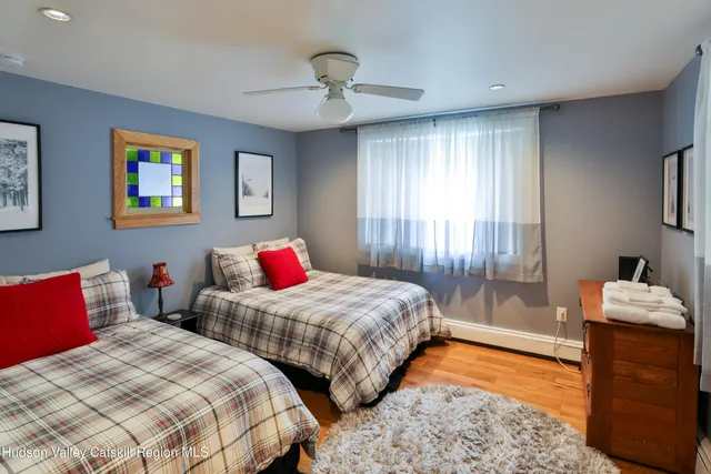 a bedroom with two beds and a chandelier