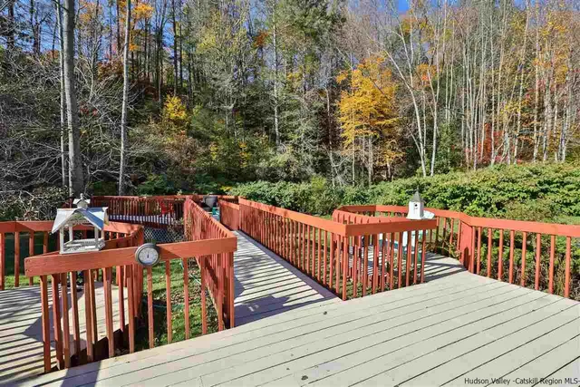 a balcony with wooden floor and fence
