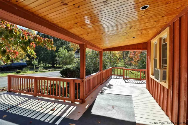 a view of a balcony with wooden floor