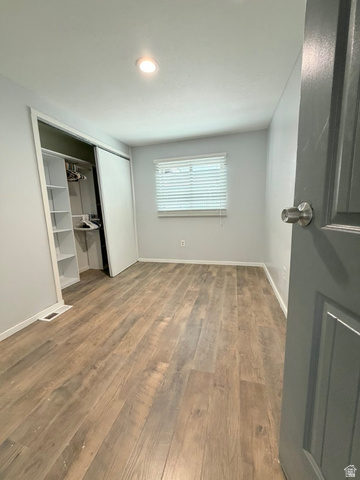 2491 Highway 89, Unit 114 Pleasant View, UT 84404 - Photo 12 of 18 Unfurnished bedroom featuring light wood-type flooring and a closet