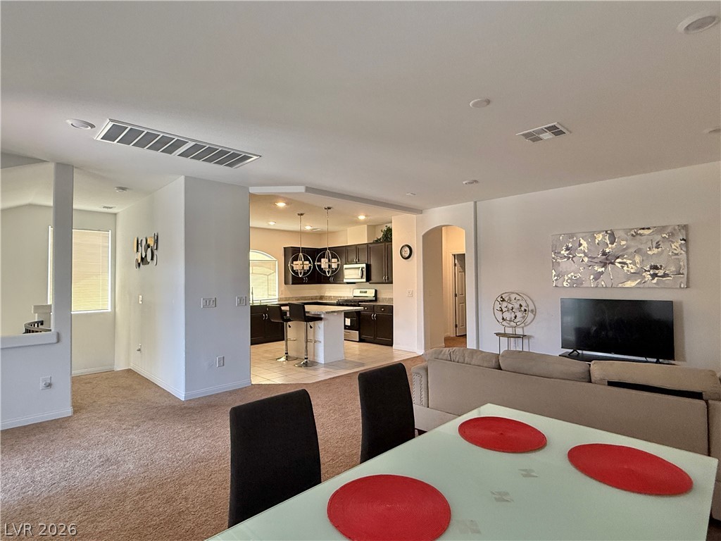 7777 South Westwind Road Las Vegas, NV 89139 - Photo 46 of 46 An open floor plan seamlessly connects the kitchen and living spaces, fostering a fluid layout.