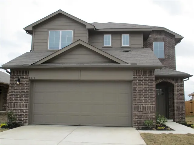 a front view of a house with a wooden fence