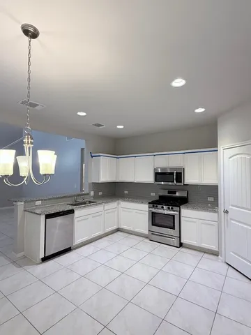 a stove top oven sitting inside of a kitchen