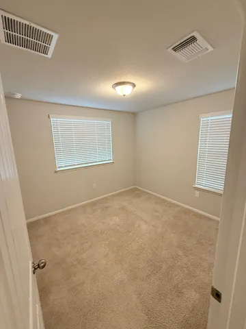 an empty room with a empty space and windows