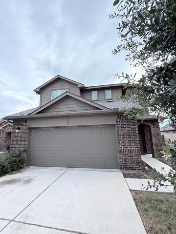a front view of a house with garage