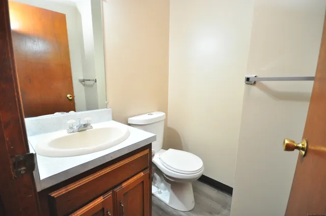 a bathroom with a sink a toilet and a mirror