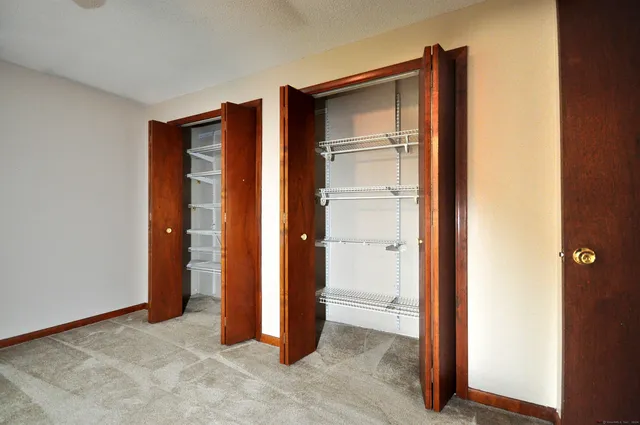 a front view of a house with a chair and tables