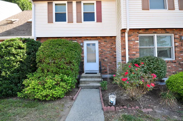 a view of a house with flower garden