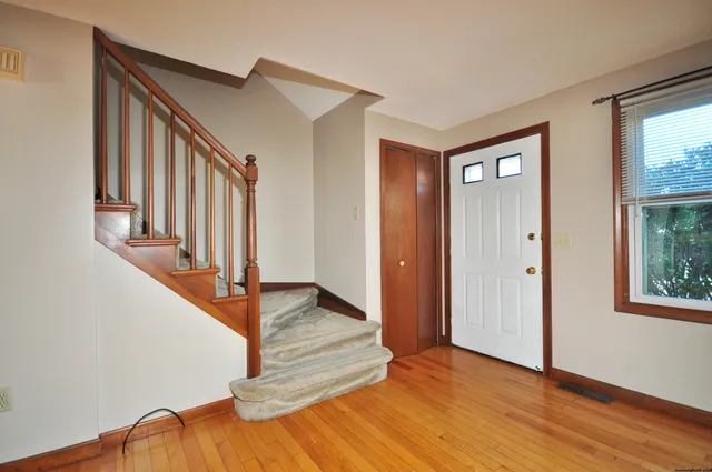 a view of entryway with wooden floor and stairs