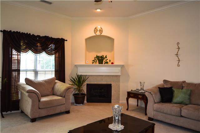 Open concept living space makes family time and entertaining a breeze. Lovely fireplace and inset detail above mantle.