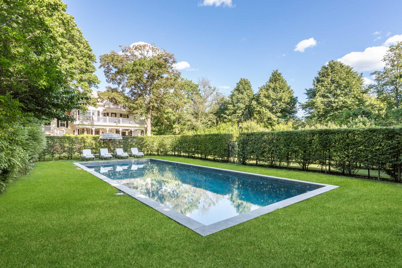 225 First Neck Lane Southampton, NY 11968 - Photo 2 of 32 a view of a swimming pool and a yard