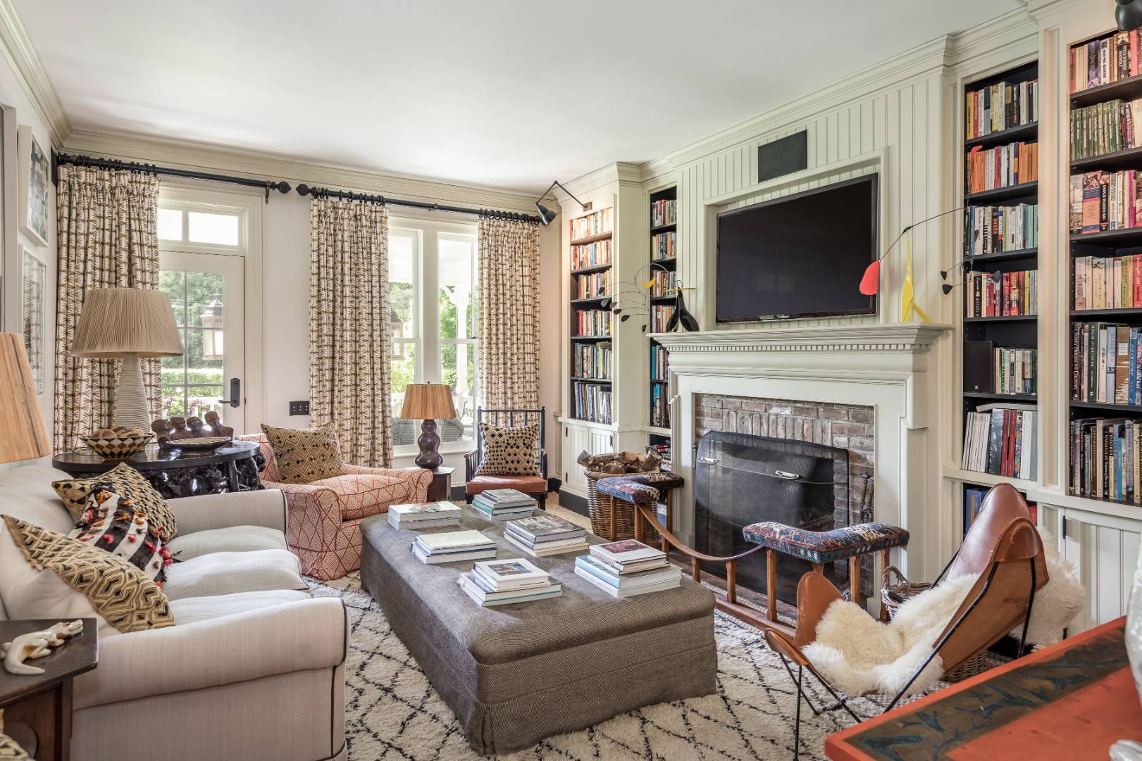 225 First Neck Lane Southampton, NY 11968 - Photo 12 of 32 a living room with furniture a flat screen tv and a fireplace