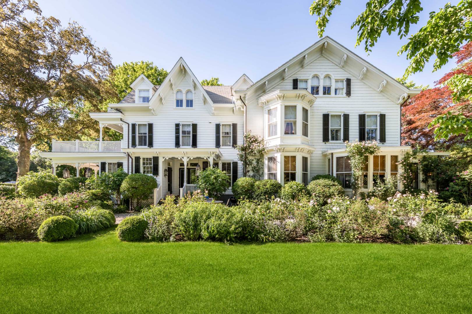 225 First Neck Lane Southampton, NY 11968 - Photo 3 of 32 a front view of a house with a yard