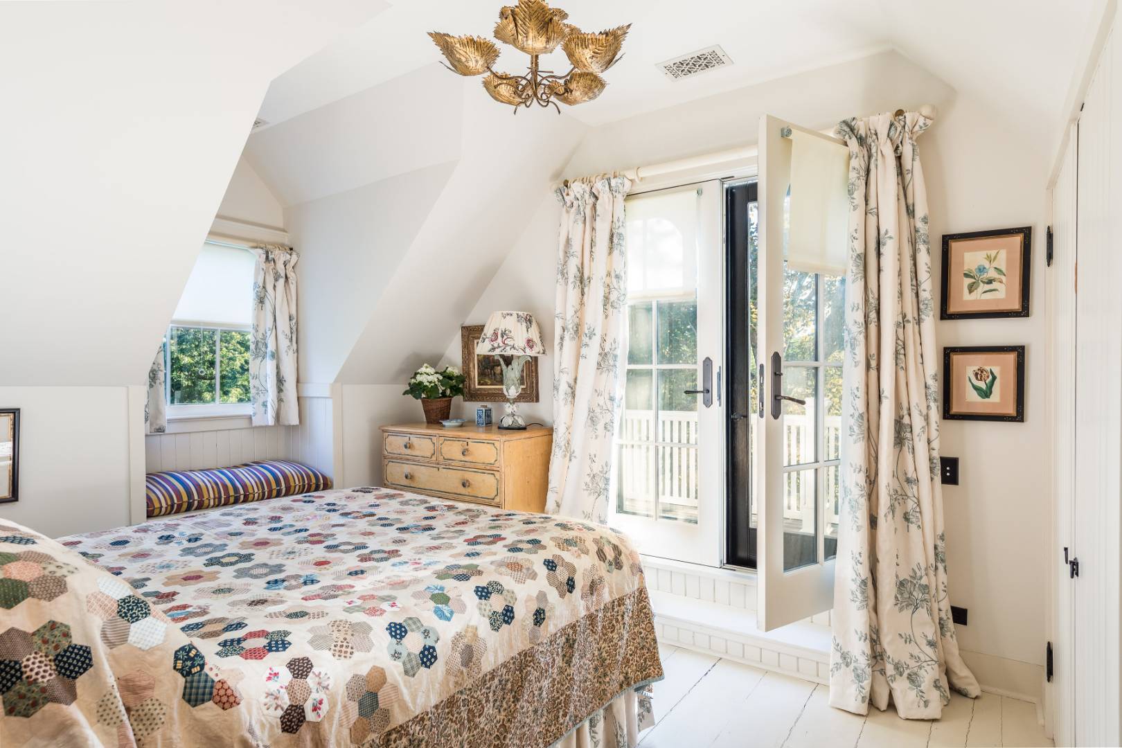 225 First Neck Lane Southampton, NY 11968 - Photo 28 of 32 a bedroom with a large bed and a chandelier