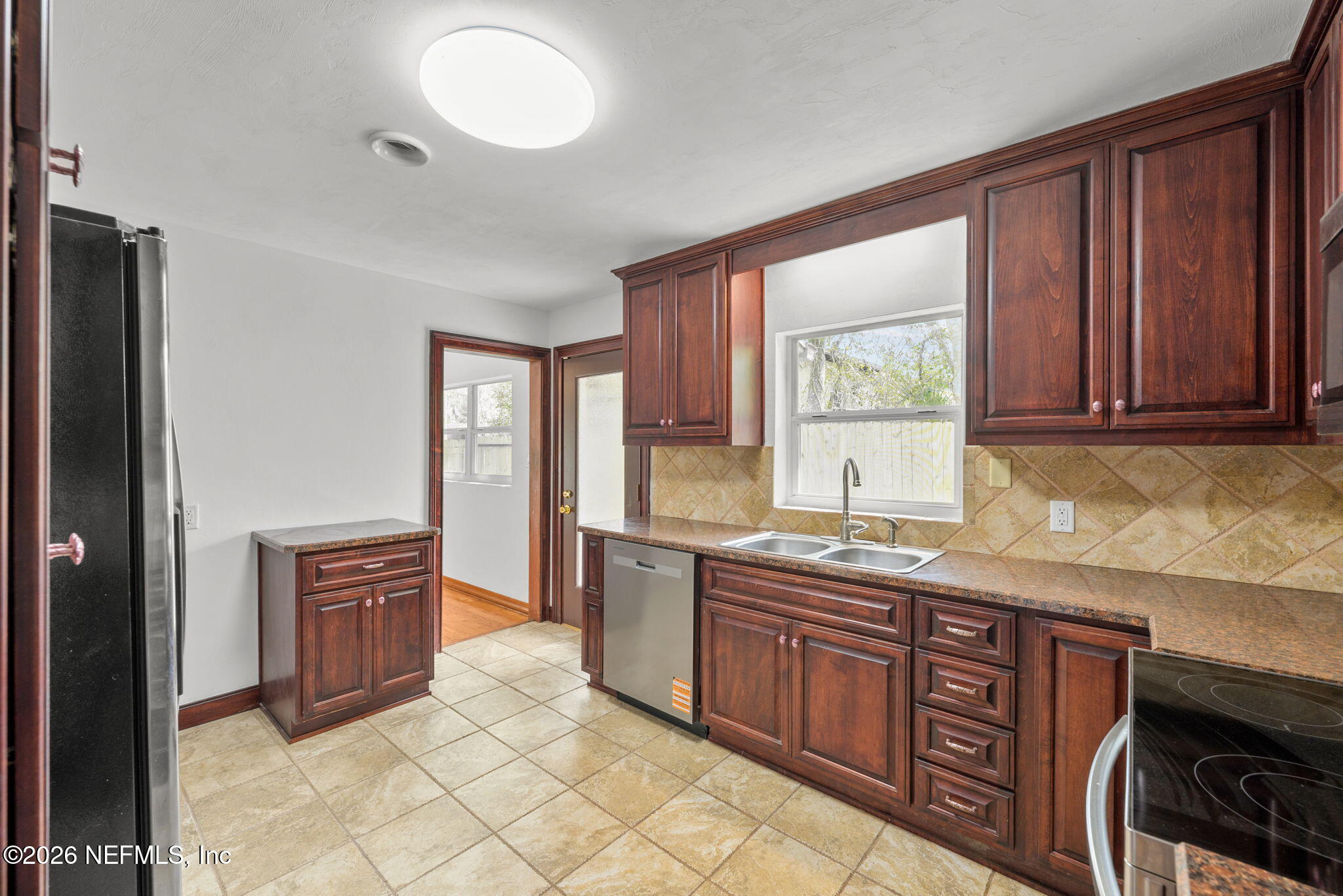 2003 Laurel Street Palatka, FL 32177 - Photo 12 of 31 a kitchen with stainless steel appliances granite countertop a stove a sink and a refrigerator