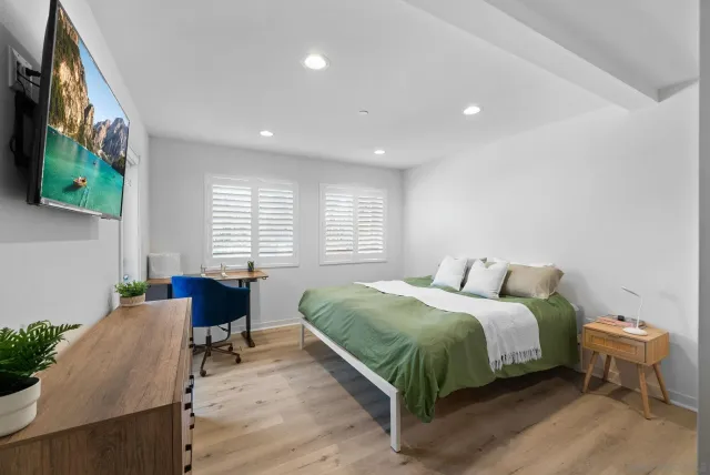 a bedroom with a bed and a chair