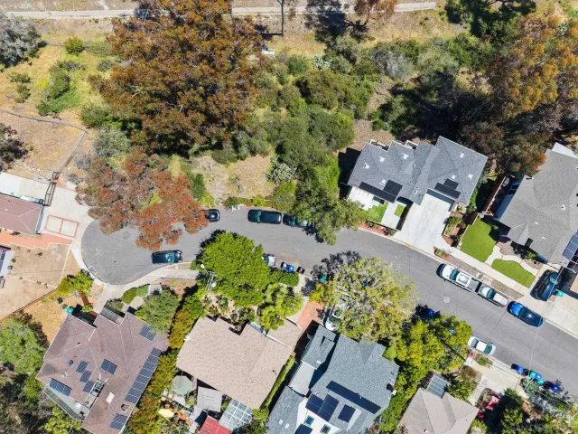 an aerial view of a houses with a yard